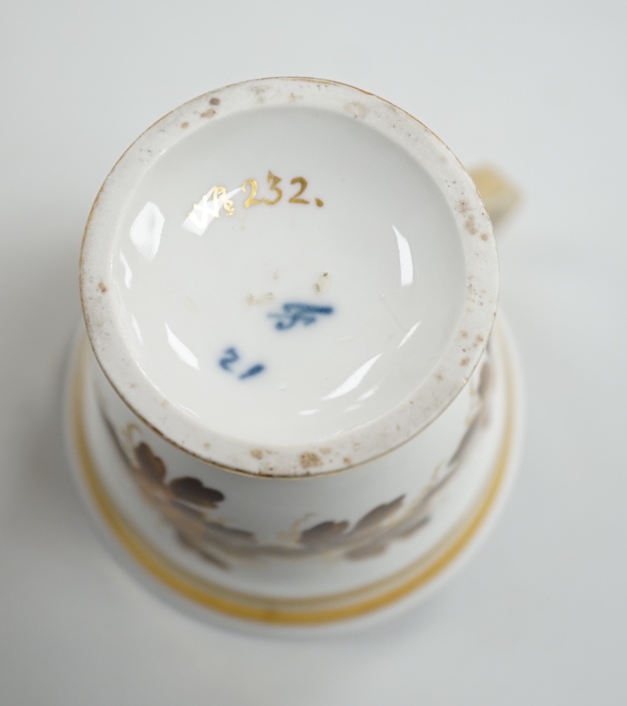 An early 19th century Furstenburg brown and white cup and saucer, saucer diameter 13cm